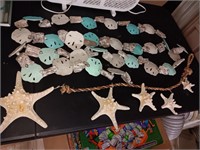 3 strings of starfish and sand dollars. Starfish