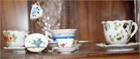 SELECTION OF MINI TEACUPS AND SAUCERS