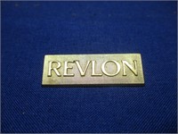 Revlon pin.
