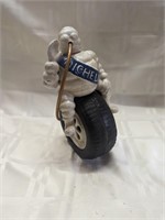 Michelin Man sitting on a tire cast iron figure