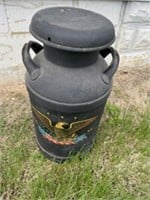 Old milk can painted black with eagle