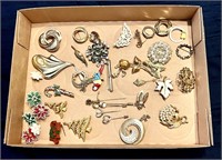 Flat of costume jewelry brooches and pins