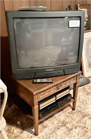 End table with 27" Magnavox TV, VCR, tapes