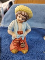 Porcelain Figurine of a Boy with a Patch on Pants
