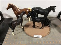 4 horses (3 black, 1 brown)