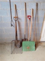 Gardening tools including shovels, a rake and
