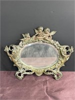 Antique metal angel mirror stand is broken on the