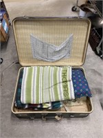 Vintage suitcase with linens inside