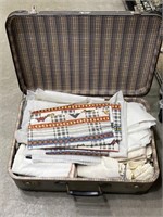 Vintage suitcase with linens inside