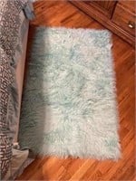 Two fluffy sea green bedroom rugs, one rectangle