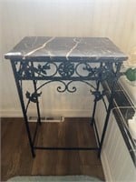 Marble top and metal table with leaf flourish