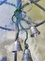 3 silver metal bells hanging from a metal ring