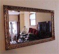 Beveled wall mirror in ornate frame, 37" x 24"
