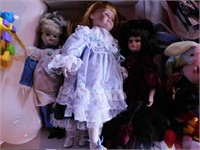 4 porcelain dolls w/ glass eyes & fancy dresses,