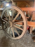 Antique heavy wood wagon wheel. 53in with metal