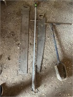 (2) antique saws and post hole digger
