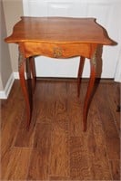 Parlor table with curved legs and scalloped top