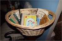 Wicker laundry basket containing cookbooks -
