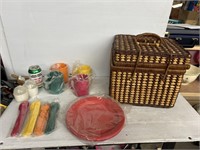 Wicker basket with plastic colorful dishes picknic