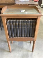 Glass top cabinet with vintage encyclopedias.