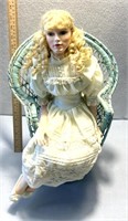 Porcelain doll with chair