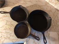 Three cast iron pans