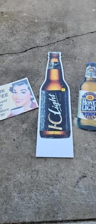 Metal JW Dundees beer sign and two cardboard signs