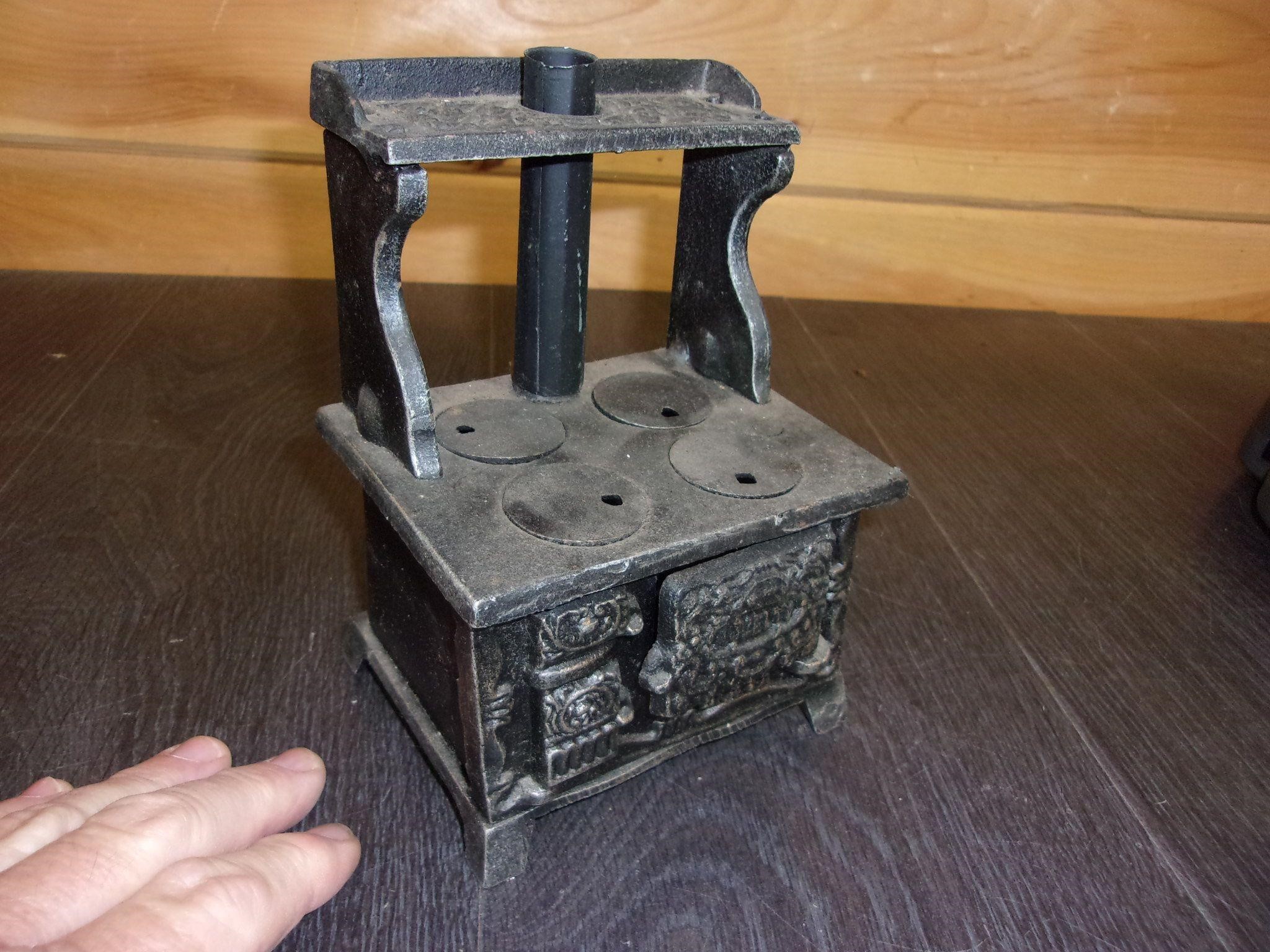 old cast iron toy stove with all lids