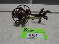 Antqiue metal horse with rider and a bell wagon