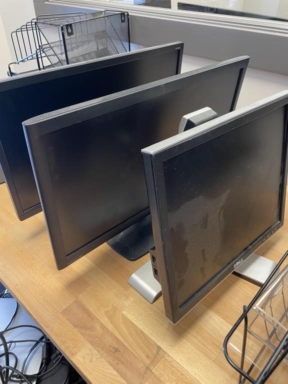 Three flat-screen computer monitors