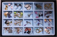 Glass top showcase full of earrings,
