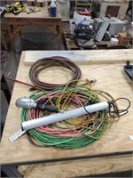 Assorted extension cords, air hose, trouble