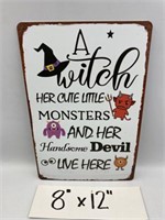 A WITCH REPRODUCTION TIN SIGN