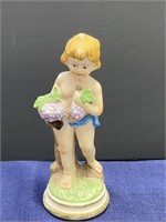Child with grapes figurine