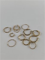 Several pairs of 14kt gold hoop earrings with a to