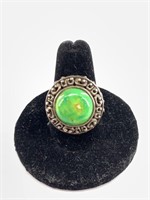 Unique ring with large green stone in ornate silve
