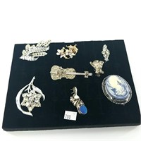 Lovely display of brooches almost all in silver to