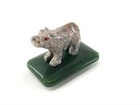 Carved in Peru,  stone bear set on a polished gree