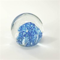 Round glass paperweight with artistic blue formati