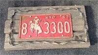1967 Wyoming license plate on barnwood
