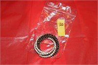Black and white circled brooch