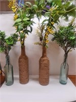 Four Artificial Plants in Decorative Bottles