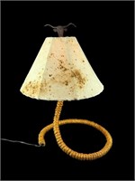 A Cowhide Lamp Shade On A Twisted Rope Base