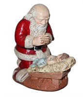ceramic kneeling Santa over baby Jesus music box