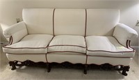 STUFFED CREAM-COLORED SOFA WITH RED TRIM AND