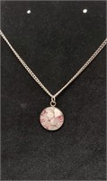 Rose quartz pendant on silver chain necklace.