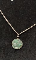 Fluorite stone pendant on silver chain necklace.