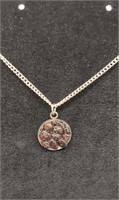 Garnet stones pendant on silver chain necklace.