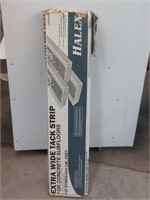 Box of extra wide tack strip for concrete floors