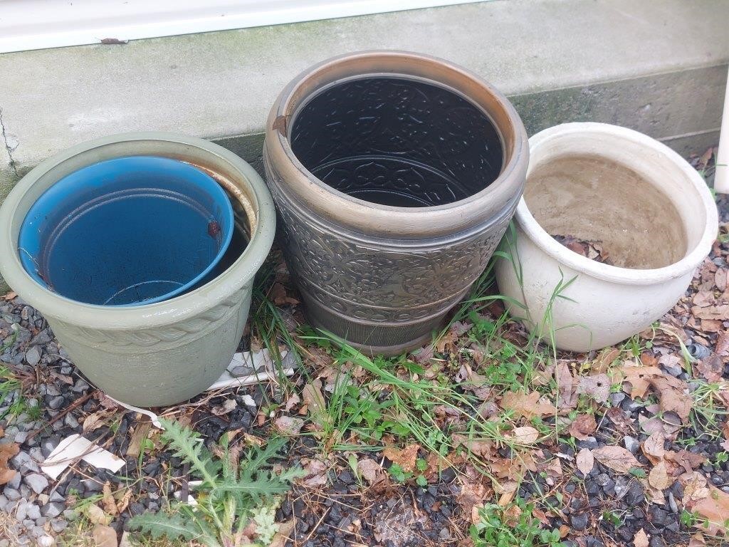 Three plastic flower pots and one concrete